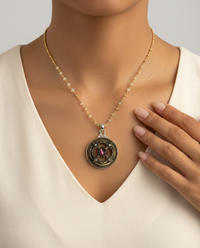 Victorian Pierce Ornate Brass Button with Purple and Rhinestone Glass Accent set in Sterling Silver — worn on model