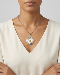 Victorian Carved Pearl Button w/ Tourmaline Center set in Sterling Silver Pendant w/ Tanzanite Stone Necklace — worn on model